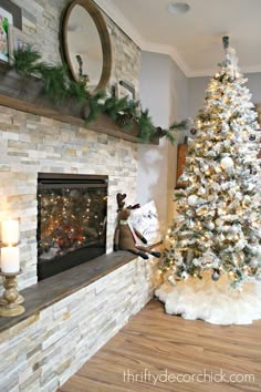 a decorated christmas tree sitting in front of a fireplace