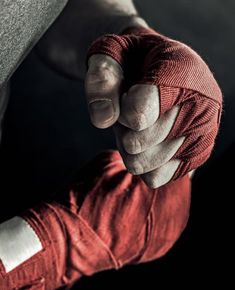 a close up of a person wearing red gloves