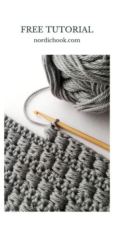 the crochet stitch is next to a ball of yarn and a knitting needle