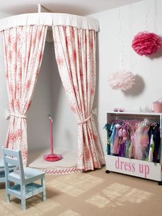 a child's bedroom decorated in pink and white with drapes on the windows