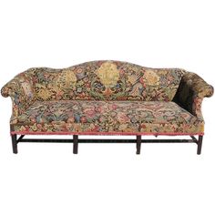 an ornately decorated couch with wooden legs