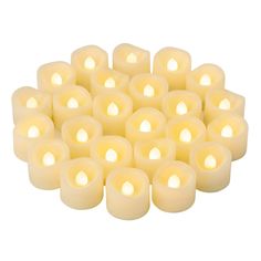 many white candles are arranged in a pyramid