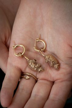 There's just nothing cuter than an opossum. That's why I had to make our favorite neighborhood critter into jewelry! These Opossum Earrings were cast from a tiny opossum sculpture I carved by hand. Gold-colored opossum earrings feature a solid bronze opossum charm holding onto a 14k gold-filled huggie-style hoop earring with its tail. Silver opossum earrings feature a solid sterling silver opossum charm on a sterling silver hoop. Earrings are nickel-free and come on a cute card back that's fun t Opossum Jewelry, Sterling Silver Hoops, Silver Hoops, Jewelry Earrings Hoops, Cute Cards, Handcrafted Jewelry, Etsy Earrings, Hoop Earrings, Jewelry Earrings