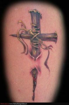 a tattoo with a cross on it and a snake wrapped around the cross is shown