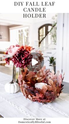 fall leaf candle holder on a dining room table with flowers and candles in the center