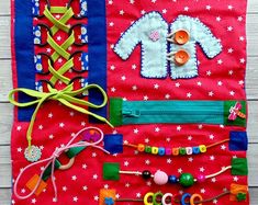 an assortment of sewing and crafting items on a red cloth with white stars in the background