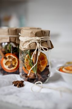 holiday spice stove top potpouri with orange slices and cinnamons in glass jars