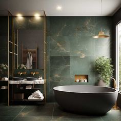 a large bathtub sitting next to a window in a bathroom with green marble walls