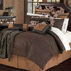 a bed covered in brown and white comforters