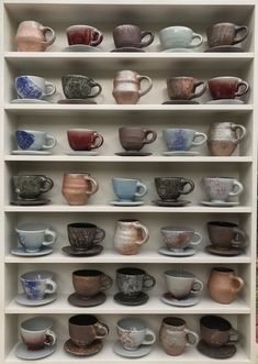 a shelf filled with lots of cups and saucers