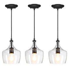 three glass pendant lights hanging from the ceiling