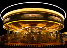 a merry go round at night with lights on