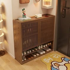 a wooden cabinet with shoes on it in a hallway next to a door and rug