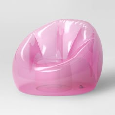 a pink chair sitting on top of a white floor