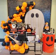 a halloween party with balloons, decorations and pumpkins in the shape of a ghost