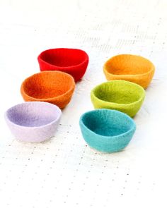 five small bowls sitting on top of a table