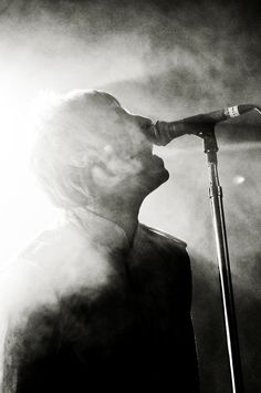 a man standing in front of a microphone