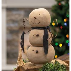 a snowman sitting on top of a wooden block