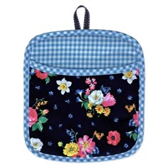 a blue and white checkered backpack with flowers on the front, hanging from a black cord