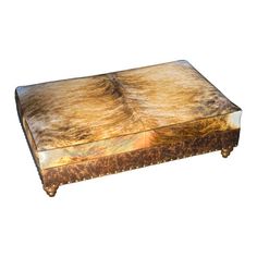 an old wooden box with fur on the top and bottom, sitting in front of a white background