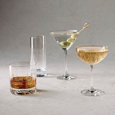 three glasses filled with different types of drinks