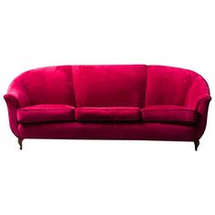 a red couch sitting on top of a white floor