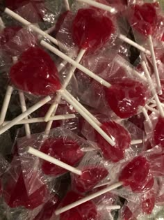 some lollipops are sitting on top of each other in plastic wrappers