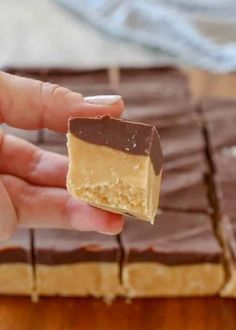 a hand holding a piece of peanut butter fudge