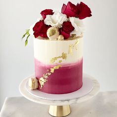 a white and pink cake with red flowers on top is featured in an instagram