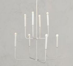 a white chandelier with candles hanging from it