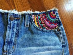 an old pair of jeans with colorful beading on them