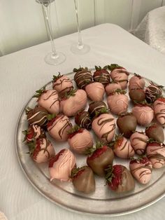 chocolate covered strawberries are arranged on a silver platter