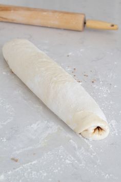 an uncooked pastry next to a rolling pin