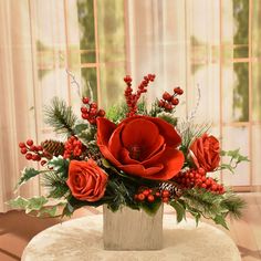 a vase filled with red flowers on top of a table