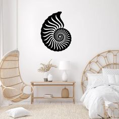 a bedroom with a rattan chair and wall decal in the shape of a shell