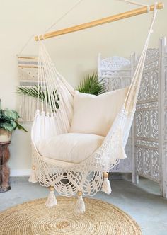 a white hammock chair sitting on top of a rug