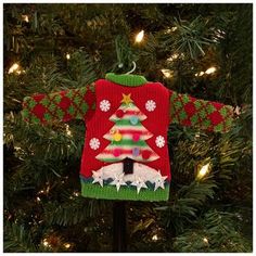 an ugly sweater ornament hanging from a christmas tree