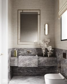 a white toilet sitting next to a sink in a bathroom under a mirror above it