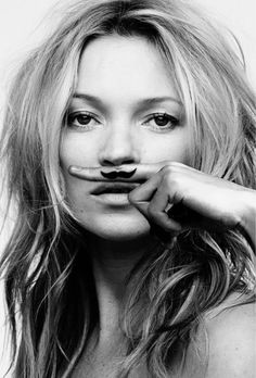 a woman with fake mustaches on her face is posing for a black and white photo