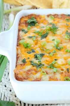 a casserole dish with cheese and green onions