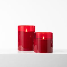 two red candles sitting next to each other