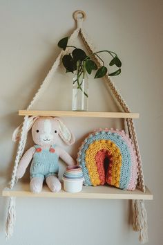 a crocheted stuffed animal sitting on top of a wooden shelf