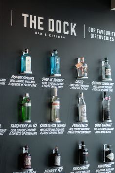 the wall has many different types of liquor on it