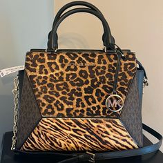 Crafted With Blend Of Animal-Print Calf Hair, Leather And Logo Print, The Prism Satchel Will Lend Geometric Edge To The Season’s Luxe Looks. The Compact Design Unzips To Reveal An Interior That’s Roomy Enough To Store Everyday Essentials. Wear It As A Crossbody Bag Or Carry It By The Top Handles. Top-Handle Bag Printed Calf Hair/Leather/Logo-Print Canvas 100% Leather Trim 1: 100% Calf Hair Gold Tone Hardware 12"W X 10"H X 5"D Handle Drop: 4.25" Exterior Details: Front Snap Pocket Interior Detail Leopard Print Handbags, Animal Print Handbags, Exterior Details, Michael Kors Purse, Leather Logo, Purses Michael Kors, Calf Hair, Printed Bags, Handle Bag