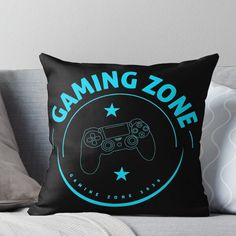 a black and blue gaming zone throw pillow on a couch with the words, gaming zone