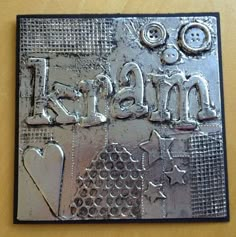 a close up of a metal plaque on a table