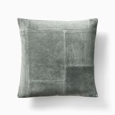 a gray pillow with two different squares on the front and one square in the back