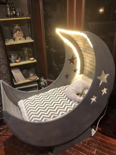 a child's bed made to look like the moon and stars are on display