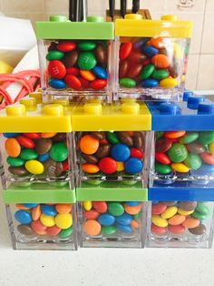 several plastic containers filled with different colored candies