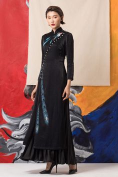 Elevate your wardrobe with our ao dai. Designed with sophistication in mind, this ao dai features a sleek sheath silhouette and long sleeves, creating a timeless and elegant look. Made from high-quality viscose, it offers both comfort and style, perfect for any occasion. Black Dress Embroidery Design, Black Dress Embroidery, Evening Dresses Midi, Iridescent Fabric, Saigon Vietnam, Mean Blvd, Indian Designer Outfits, Abayas Fashion, Black Skirt